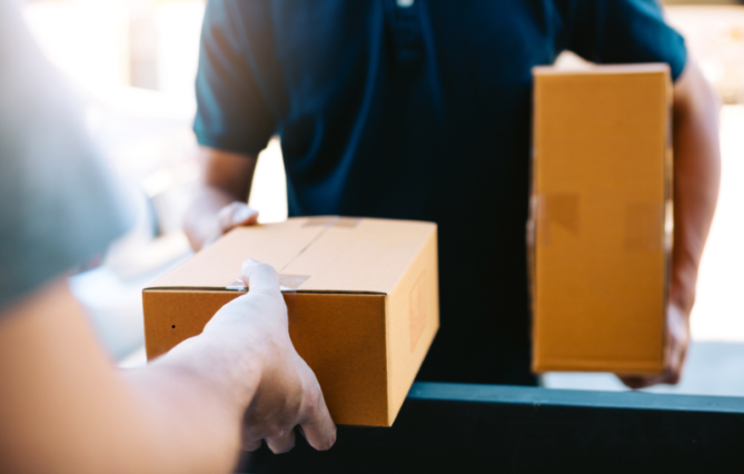 A person receiving a package from a courier